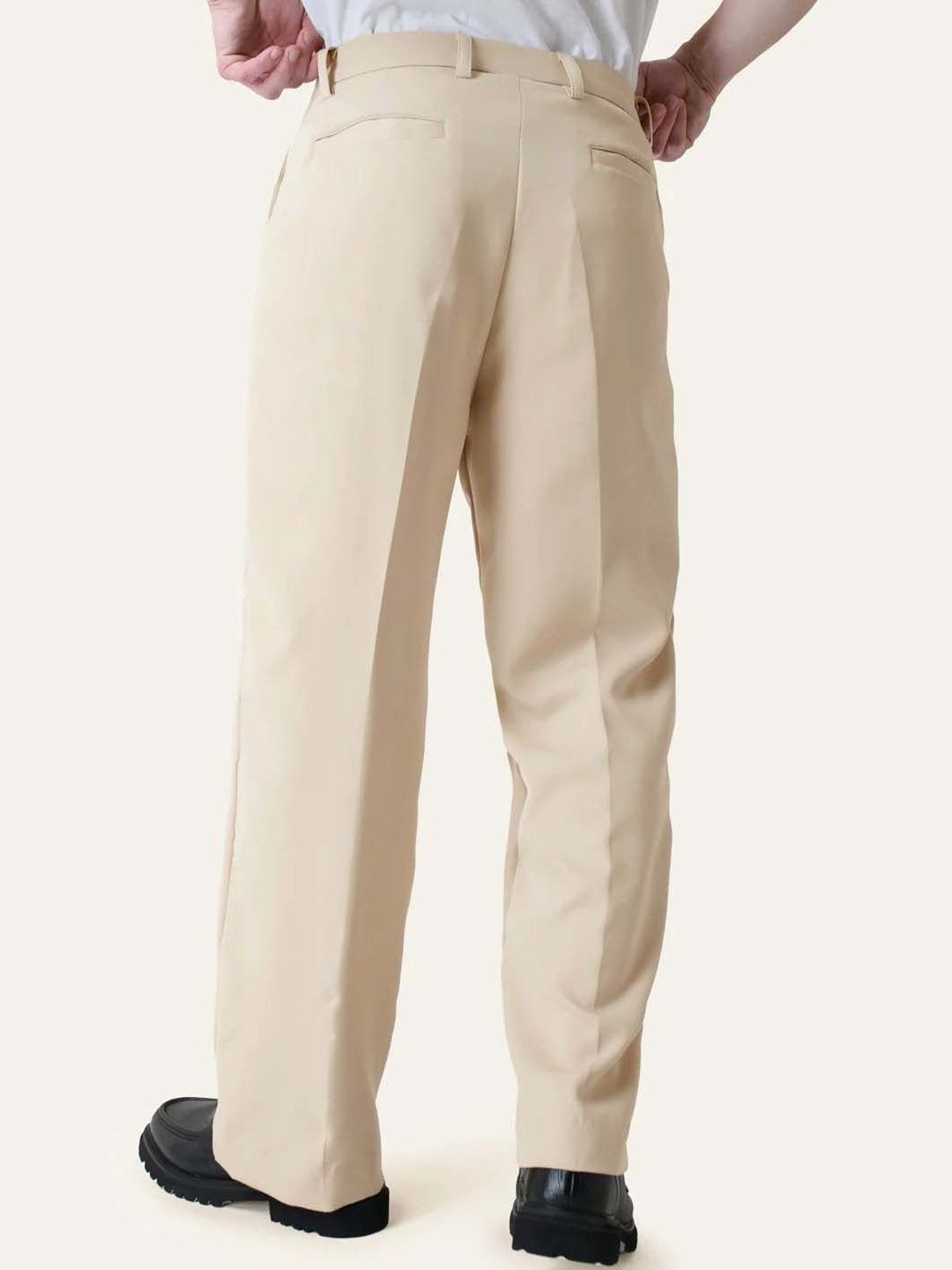 Men Pleated Trousers in relaxed fit, solid beige color, showcasing the back view of stylish korean pants.